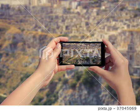 Female taking picture of old town Matera in Italy 37045069