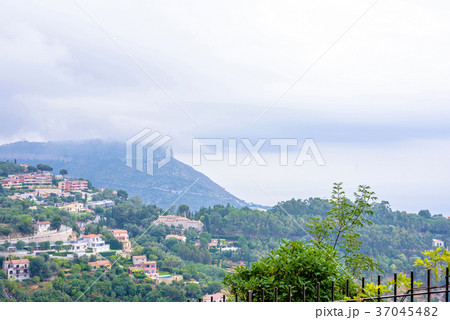 Daylight foggy view to Eze village, trees 37045482