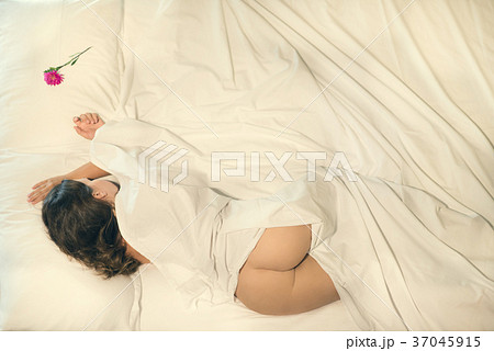 Beautiful naked female sleeping in bed.  37045915