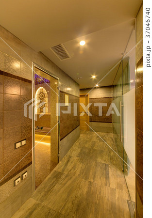 A corridor with a marble floor and tiled walls in A corridor with a marble floor and tiled walls in 37046740