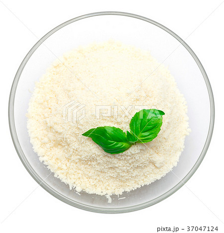 grated Parmesan cheese in glass bowl on white 37047124