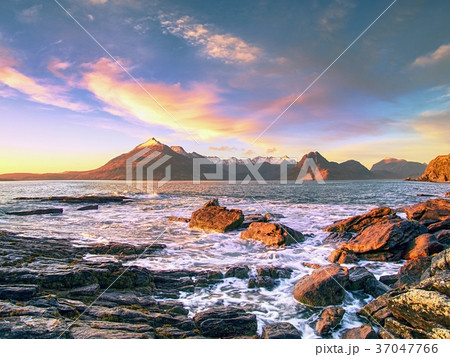 Rocky shore with sea water and large cracked rocks 37047766