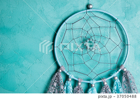 Dream catcher on aquamarine wall background Dream catcher on aquamarine wall background 37050488