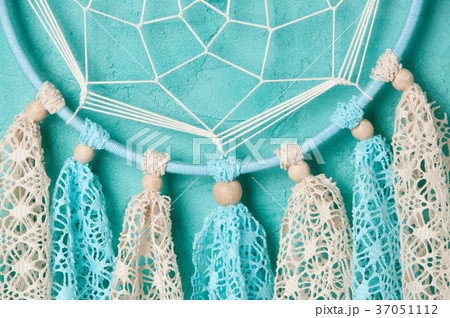 Dream catcher on aquamarine wall background Dream catcher on aquamarine wall background 37051112