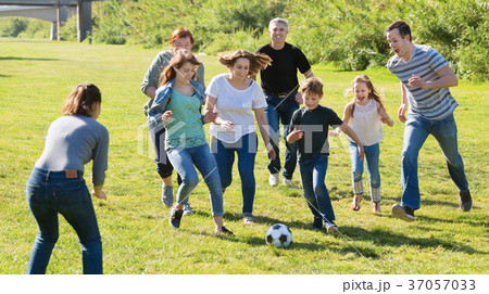 People of different ages taking photos on the lawn 37057033