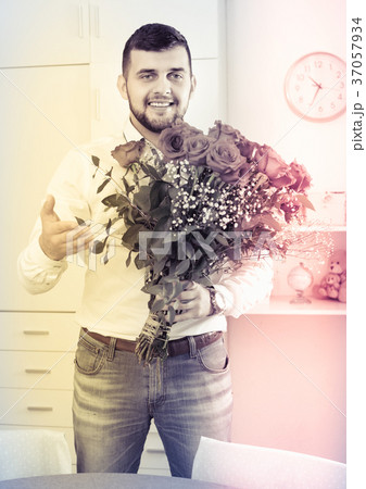 Young man ready to present flowers to woman Young man ready to present flowers to woman 37057934