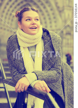 Cheerful young girl in scarf at the street Cheerful young girl in scarf at the street 37058144