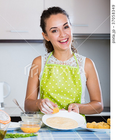 girl preparing croquettes for tasty dinner girl preparing croquettes for tasty dinner 37058349