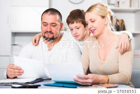 Smiling family with papers Smiling family with papers 37058551