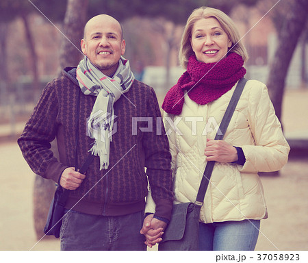 Portrait of positive mature couple at autumn day Portrait of positive mature couple at autumn day 37058923