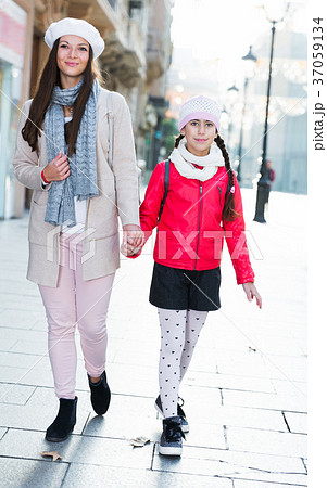Female and child in the historic center going Female and child in the historic center going 37059134