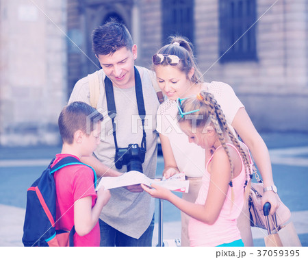 Happy family travelers with two kids with map outdoor 37059395