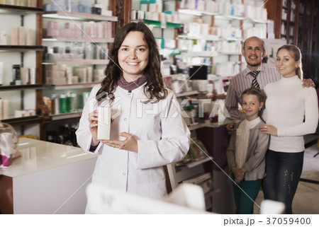 Woman pharmacist helping customers Woman pharmacist helping customers 37059400
