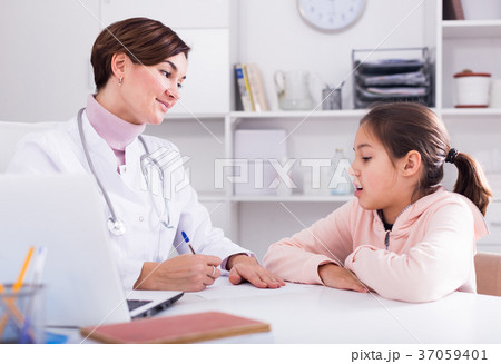 Doctor fills patient card for girl 37059401