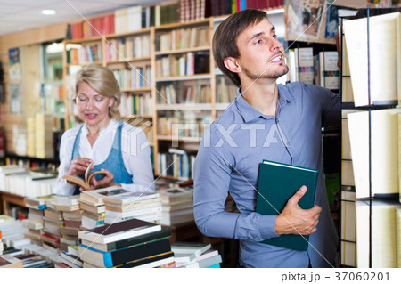 young man among bookshelves 37060201
