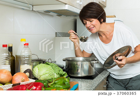 mature woman kitchen soup mature woman kitchen soup 37060365