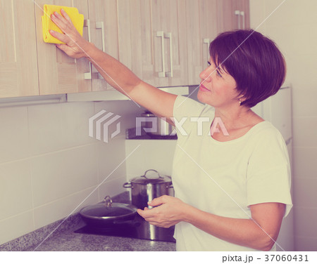 retiree woman cleaning home retiree woman cleaning home 37060431