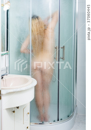 Woman taking shower in bathroom 37060445