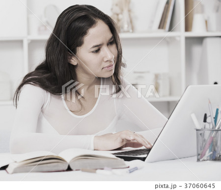 teenager female reading info in laptop teenager female reading info in laptop 37060645