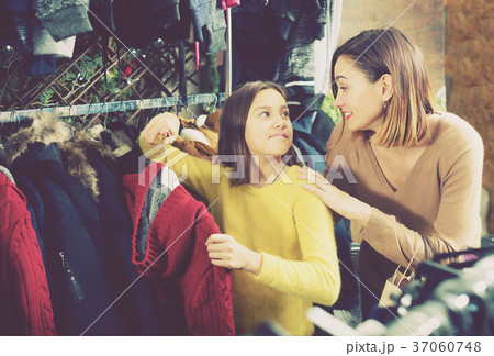 Mother and daughter deciding on warm sweater Mother and daughter deciding on warm sweater 37060748
