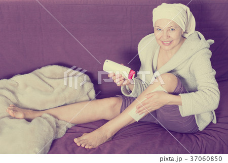 Woman doing body hair removal 37060850