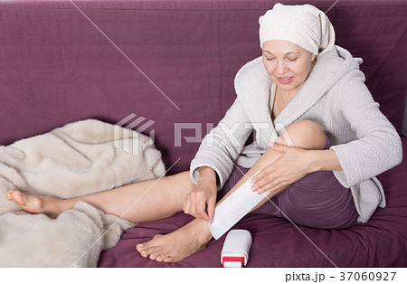 Woman doing body hair removal 37060927
