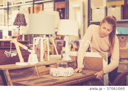 Woman near wooden table with drawers 37061060