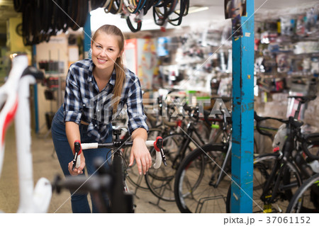 Portrait of happy girl posing with bicycle 37061152