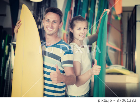 Portrait of happy couple standing with new surfboards 37061232