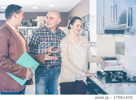 Adult seller and buyers at kitchen furniture 37061450