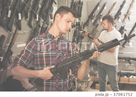 Friends choosing air-powered gun Friends choosing air-powered gun 37061752