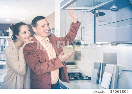 Couple looking at modern kitchen Couple looking at modern kitchen 37061806