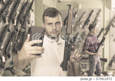 Man taking selfie with weapon Man taking selfie with weapon 37061972
