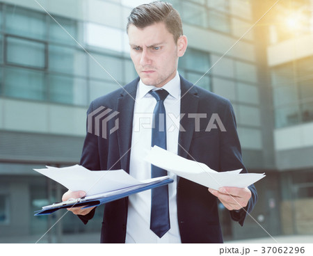 Creative director is examining documents before signing 37062296