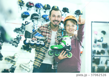 Smiling man and son boasting roller-skates 37062526