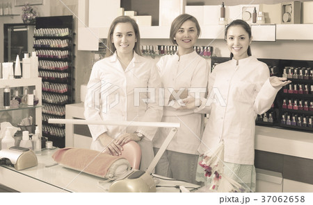 Portrait of professional manicurists at working place inviting to salon Portrait of professional manicurists at working place inviting to salon 37062658