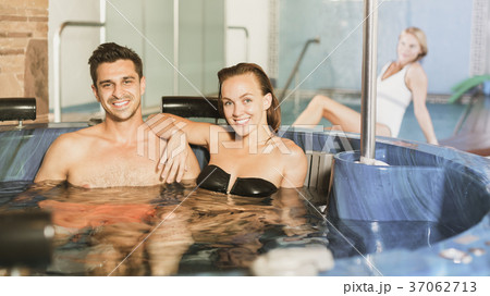Couple relaxing in spa pool 37062713