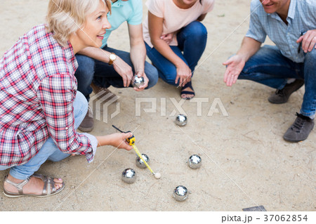 friendly mature couples playing petanque at leisure friendly mature couples playing petanque at leisure 37062854