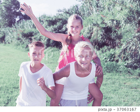 Laughing kids running on grass 37063167