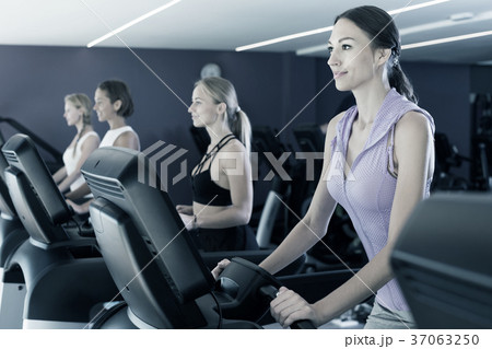 Women running on treadmills Women running on treadmills 37063250