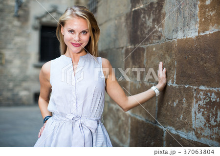 smiling woman near the stone wall 37063804