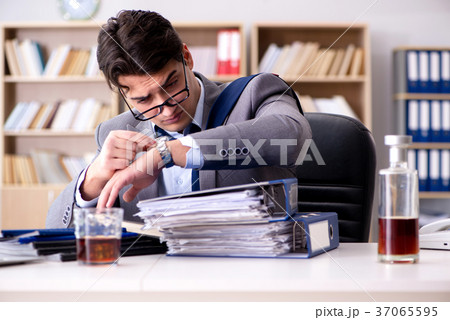 Young businessman drinking from stress 37065595