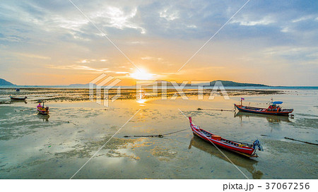 two monks walking alms on the beach. 37067256