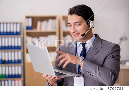 Handsome customer service clerk with headset Handsome customer service clerk with headset 37067814