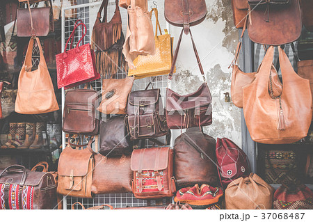Moroccan leather goods bags and slippers at market 37068487