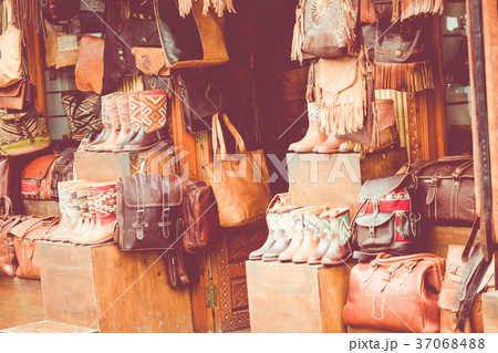 Moroccan leather goods bags and slippers at market 37068488