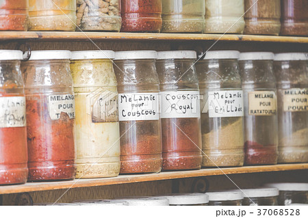 Assortment of glass jars on shelves in shop  37068528