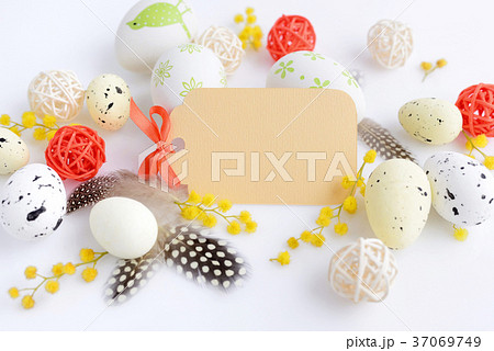 Easter eggs and mimosa flowers on white background Easter eggs and mimosa flowers on white background 37069749