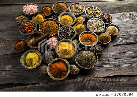 A selection of various colorful spices on a wooden A selection of various colorful spices on a wooden 37070694