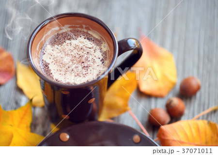 Coffee cup on the autumn fall leaves Coffee cup on the autumn fall leaves 37071011